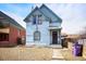 Quaint home with a unique arched window and inviting porch, blending vintage charm with curb appeal at 3643 Shoshone St, Denver, CO 80211