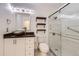 Modern bathroom featuring bowl sink, decorative shelves, and glass enclosed shower at 8220 Lamar Cir, Arvada, CO 80003