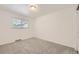 Bright bedroom featuring neutral carpeting and a large window with blinds for natural light at 8220 Lamar Cir, Arvada, CO 80003