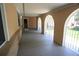 Arched covered porch entrance with gray painted floor and decorative metal security gates at 8220 Lamar Cir, Arvada, CO 80003
