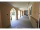 Arched covered porch entrance with gray painted floor and decorative metal security gates at 8220 Lamar Cir, Arvada, CO 80003