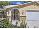 Close-up of an arched doorway with intricate metalwork and brick accents at 8220 Lamar Cir, Arvada, CO 80003