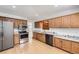 Well-lit kitchen with stainless steel appliances, granite countertops, and wood cabinets offering a functional and stylish space at 8220 Lamar Cir, Arvada, CO 80003