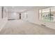 Large living room featuring neutral carpet and walls, and ample natural light at 8220 Lamar Cir, Arvada, CO 80003