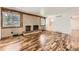 Inviting living room features a brick fireplace, hardwood floors, and natural light, creating a cozy and welcoming atmosphere at 8220 Lamar Cir, Arvada, CO 80003