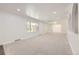 Spacious living area with light carpeting, great natural light, and neutral paint at 8220 Lamar Cir, Arvada, CO 80003