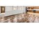 Spacious living room with hardwood floors, arched room dividers, and seamless connection to the adjacent kitchen at 8220 Lamar Cir, Arvada, CO 80003