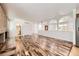 Open-concept living room with hardwood floors, fireplace, and archways, seamlessly blending comfort and style at 8220 Lamar Cir, Arvada, CO 80003