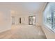 Airy living room with sliding door access and new carpeting at 8220 Lamar Cir, Arvada, CO 80003