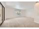 Sunlit living room featuring neutral walls and plush carpeting at 8220 Lamar Cir, Arvada, CO 80003