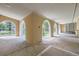 A covered patio featuring arched openings that provide views of the landscaped yard at 8220 Lamar Cir, Arvada, CO 80003