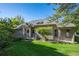 Back of house with large deck and green lawn at 7329 Windsor Dr, Boulder, CO 80301