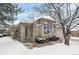 Brick ranch home with attached garage and mature trees, snow-covered landscaping at 7329 Windsor Dr, Boulder, CO 80301