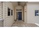 Front entrance with a dark blue door and wood deck at 7329 Windsor Dr, Boulder, CO 80301