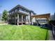 Inviting backyard featuring a pergola-covered dining area, spacious lawn, and a two-story deck at 4180 Kalamath St, Denver, CO 80211