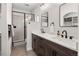 Bathroom with double sink vanity, modern shower, and sleek black fixtures at 4180 Kalamath St, Denver, CO 80211