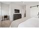 Bright bedroom with desk, dresser and tv, featuring a sliding barn door at 4180 Kalamath St, Denver, CO 80211