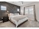 Bedroom with decorative headboard wall, plush carpeting, and bright natural light at 4180 Kalamath St, Denver, CO 80211