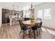 Dining area showcasing a modern kitchen with a central island and pendant lighting at 4180 Kalamath St, Denver, CO 80211