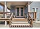 Charming front entrance featuring a wooden deck and stylish double doors at 4180 Kalamath St, Denver, CO 80211