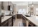 Modern kitchen with stainless steel appliances, white countertops, and stylish dark wood cabinetry at 4180 Kalamath St, Denver, CO 80211
