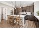 Well-lit kitchen featuring gray cabinets, stainless steel appliances, and a large island with barstool seating at 4180 Kalamath St, Denver, CO 80211