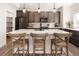 Stylish kitchen featuring gray cabinets, stainless steel appliances, and a spacious island with seating at 4180 Kalamath St, Denver, CO 80211