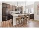 Modern kitchen featuring stainless steel appliances, quartz countertops, and seating at the central island at 4180 Kalamath St, Denver, CO 80211