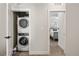 Hallway with stacked washer and dryer laundry room with modern machines at 4180 Kalamath St, Denver, CO 80211