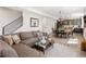 Open-concept living room with wood floors, modern staircase, and a dining area adjacent to the kitchen at 4180 Kalamath St, Denver, CO 80211