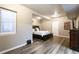 Basement bedroom with vinyl floors and a queen bed, perfect for guests at 802 Gamble Oak St, Brighton, CO 80601