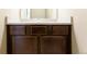 Bathroom vanity featuring dark wood cabinets, a white countertop, and a modern sink at 802 Gamble Oak St, Brighton, CO 80601