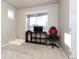 Neutral bedroom with a gaming chair and a dark wood shelf with a television at 802 Gamble Oak St, Brighton, CO 80601