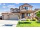 Charming two-story home featuring a two-car garage and inviting front porch at 802 Gamble Oak St, Brighton, CO 80601