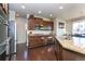 Well-lit kitchen with granite countertops, stainless steel appliances, and dark wood cabinets at 802 Gamble Oak St, Brighton, CO 80601