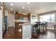 Well-lit kitchen with granite countertops, stainless steel appliances, and dark wood cabinets at 802 Gamble Oak St, Brighton, CO 80601