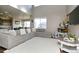 Bright living room with a high ceiling, a large sectional sofa, and natural light at 802 Gamble Oak St, Brighton, CO 80601