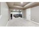Finished basement living room, carpeted and ready for furniture, with a door and open space at 802 Gamble Oak St, Brighton, CO 80601
