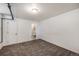A carpeted bedroom with a window and a doorway to a bathroom with a tile design at 500 E 11Th Ave # 102, Denver, CO 80203