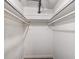 An empty, white, walk-in closet with a carpeted floor and two metal clothes-hanging bars at 500 E 11Th Ave # 102, Denver, CO 80203