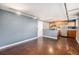 A modern living room and kitchen with stainless steel appliances, industrial accents, and neutral paint at 500 E 11Th Ave # 102, Denver, CO 80203