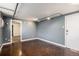 A modern living room with industrial accents, neutral paint, and a glimpse of a carpeted bedroom at 500 E 11Th Ave # 102, Denver, CO 80203