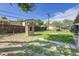 View of grassy, fenced back yard with patio area and small brick barbeque at 9095 Beechwood Dr, Thornton, CO 80229
