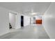 Large basement rec room with multiple access doors and painted cement floor and walls at 9095 Beechwood Dr, Thornton, CO 80229