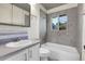 Modern bathroom featuring tiled walls, a tub-shower combination, and a vanity with storage at 9095 Beechwood Dr, Thornton, CO 80229