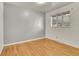 Cozy bedroom featuring hardwood floors, neutral paint colors, and a window with blinds at 9095 Beechwood Dr, Thornton, CO 80229