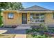 Charming brick home featuring front door, concrete steps, and large picture window at 9095 Beechwood Dr, Thornton, CO 80229