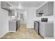 Functional kitchen featuring updated appliances, ample cabinetry, and durable tile flooring at 9095 Beechwood Dr, Thornton, CO 80229