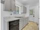 Galley kitchen featuring gray cabinets, stainless sink, laminate countertop, and black dishwasher at 9095 Beechwood Dr, Thornton, CO 80229