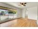 Bright living room featuring hardwood floors, large window and a ceiling fan at 9095 Beechwood Dr, Thornton, CO 80229